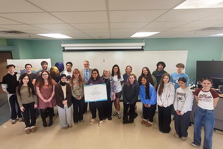 Dr Jessica Leveto surrounded a group of students after the announcement of her Distinguished Teaching Award