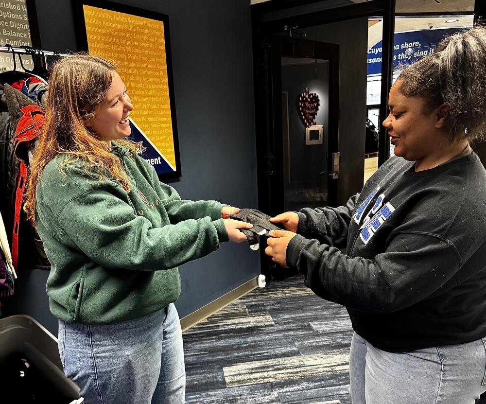 student receiving donated gloves at CARES Center