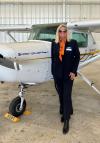 Alumni Sharon Wilder stands by her plane in the 51�Թ��� hangar. 