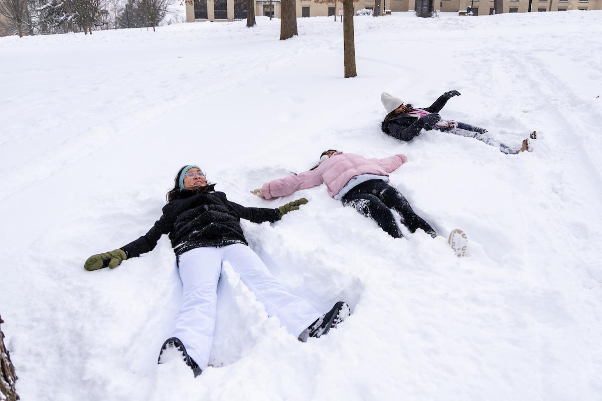 Students making snow angels on Front Campus.