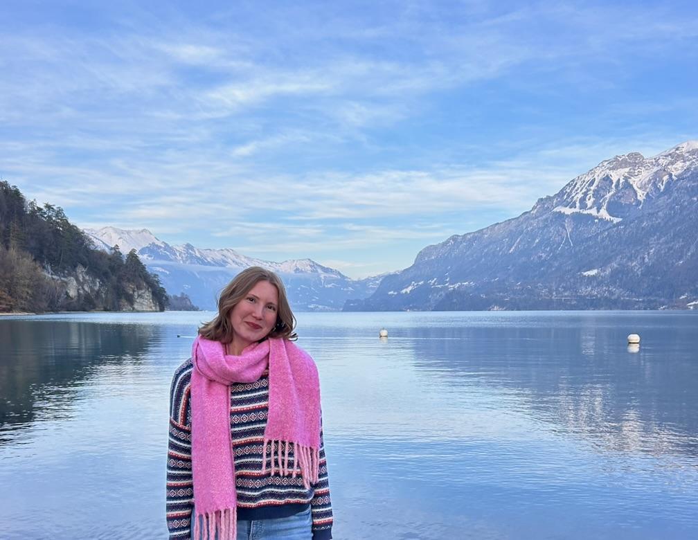 Kent State Honors College student Korren Cullom stands for a photo with water and mountains in the background.