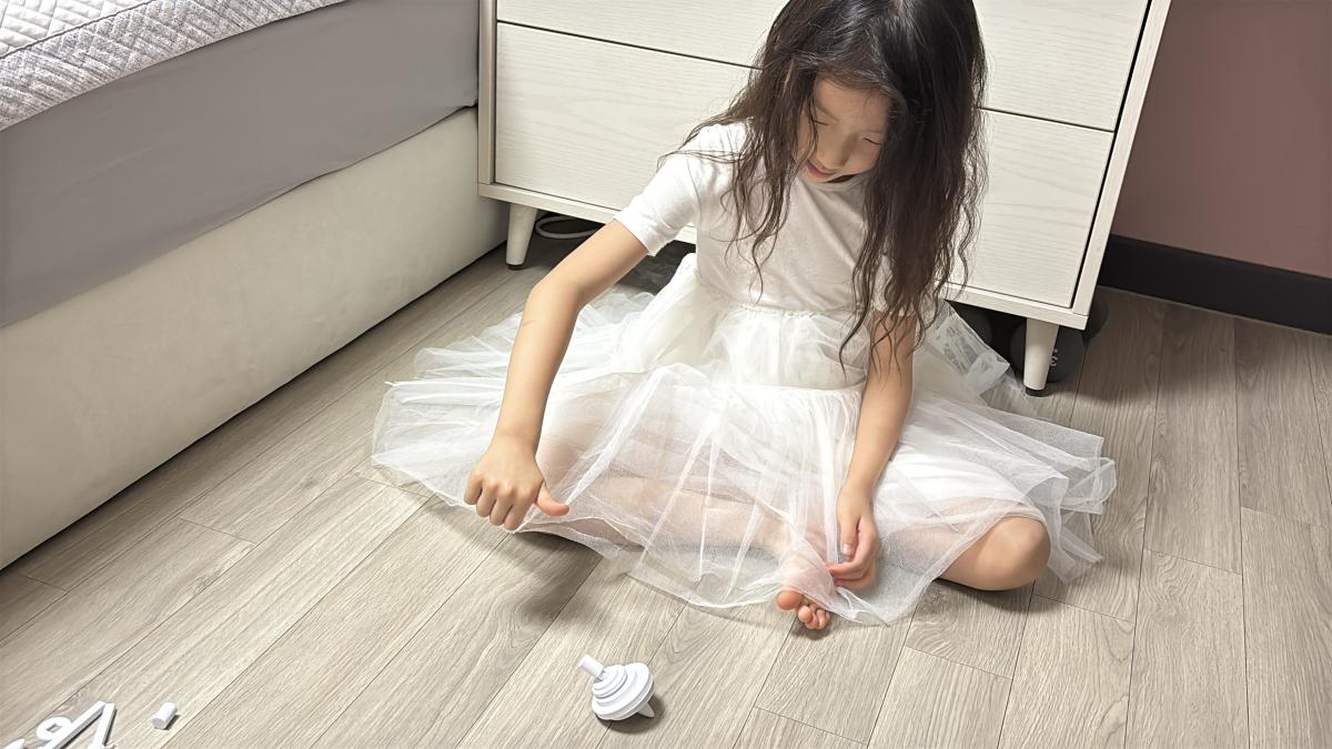 A child playing with a spinning top