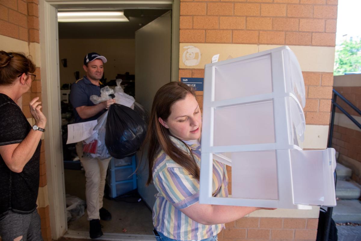 University Housing employees help to load clothing and other items left behind in residence halls for donation to Family and Community Services in Ravenna.
