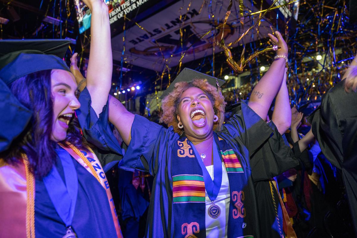 New ����ɫ��ҹ University graduates celebrate as blue and gold streamers are released during their commencement ceremony. (Photo credit: Bob Christy, ����ɫ��ҹ University)
