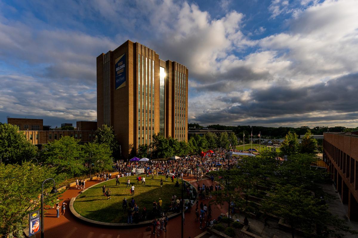 's Library stands tall on a sunny evening while participants of Blastoff fill the courtyard.