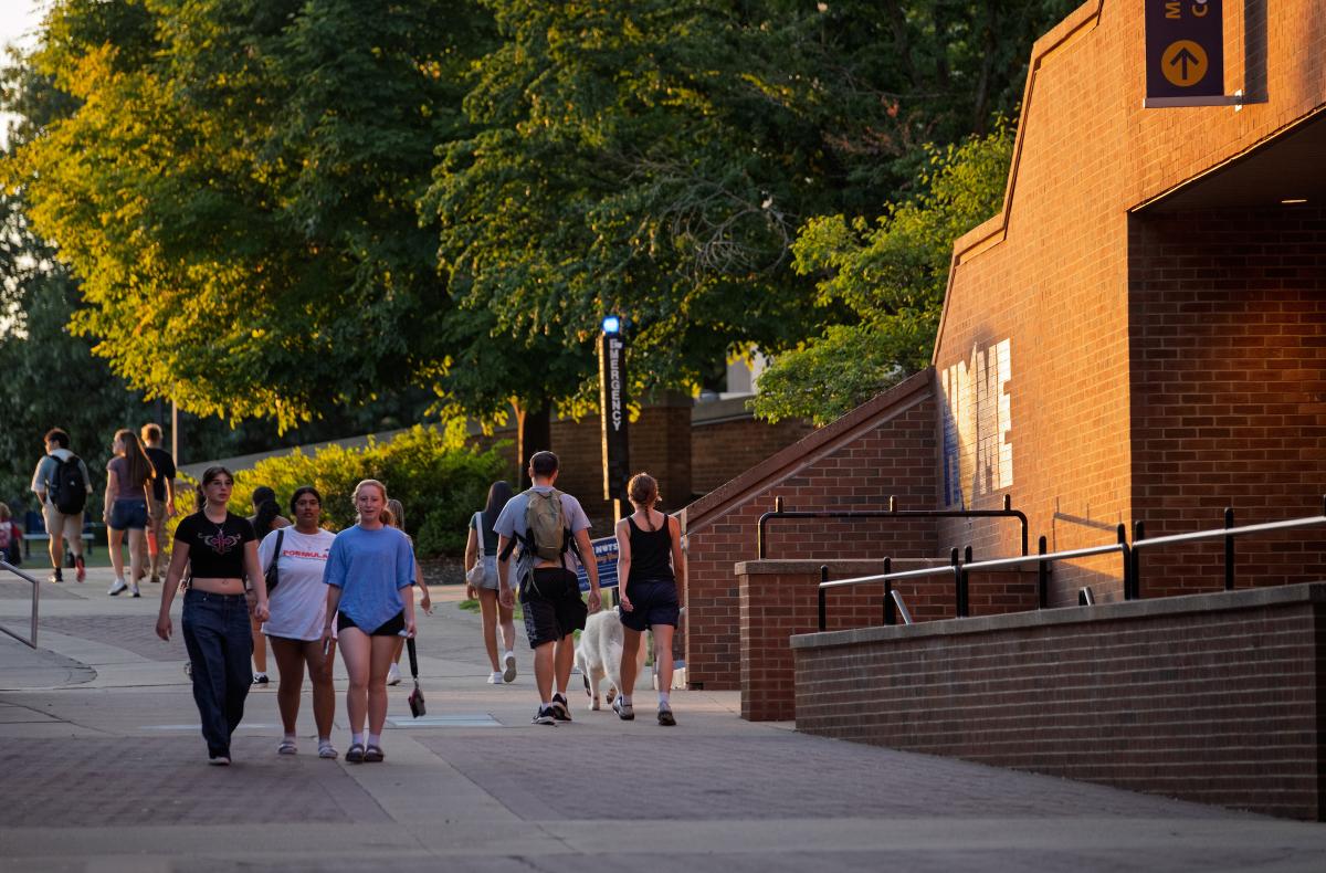 Students walk near 's Student Center during Golden Hour