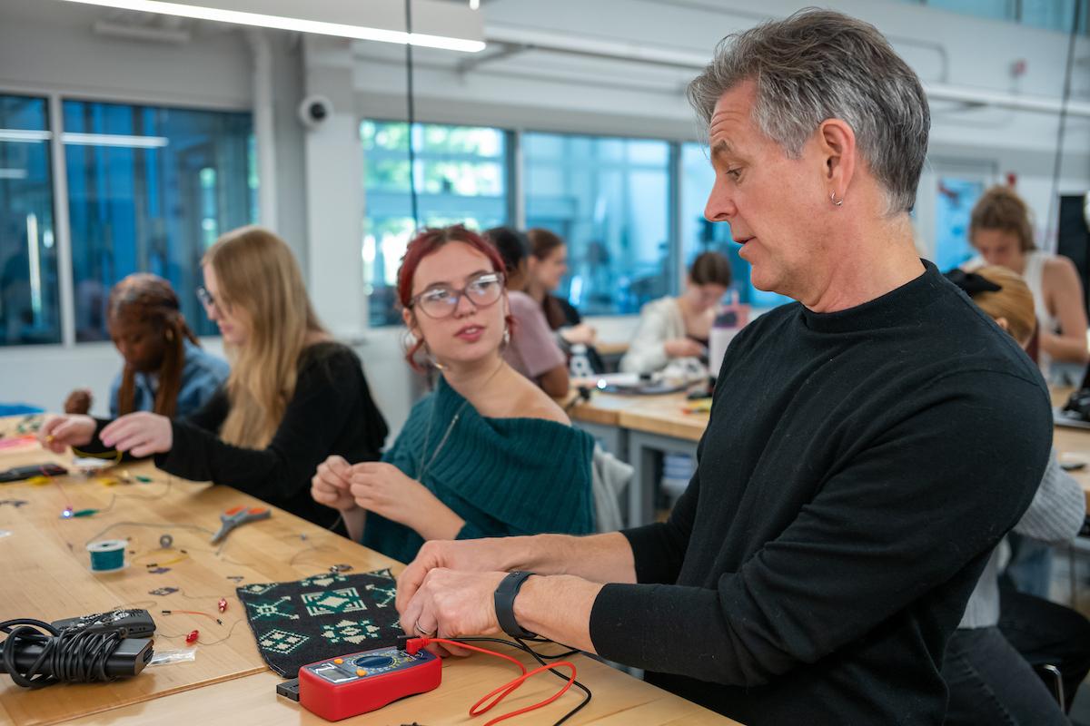 JR Campbell with a student at the Soft Circuits and Smart Textiles Workshop.