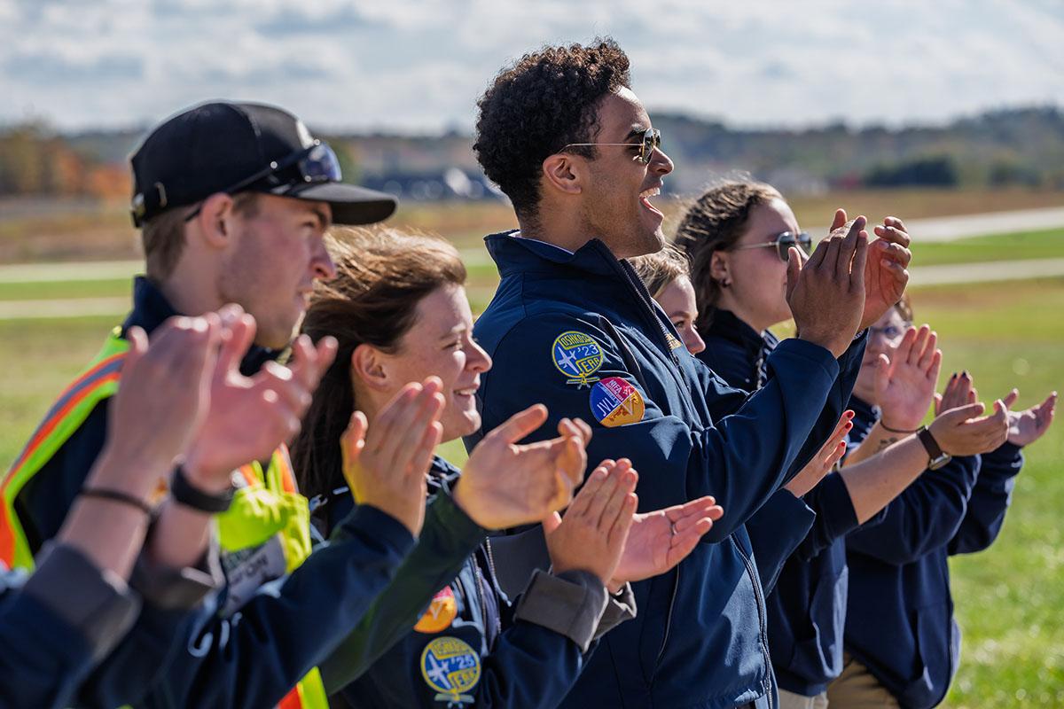 A group of student pilots applauds