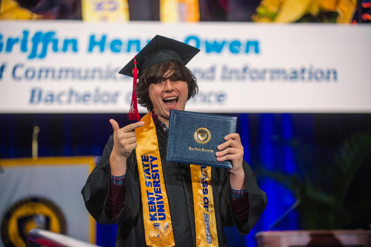 A student shows off his diploma at ������ State's Commencement 2025