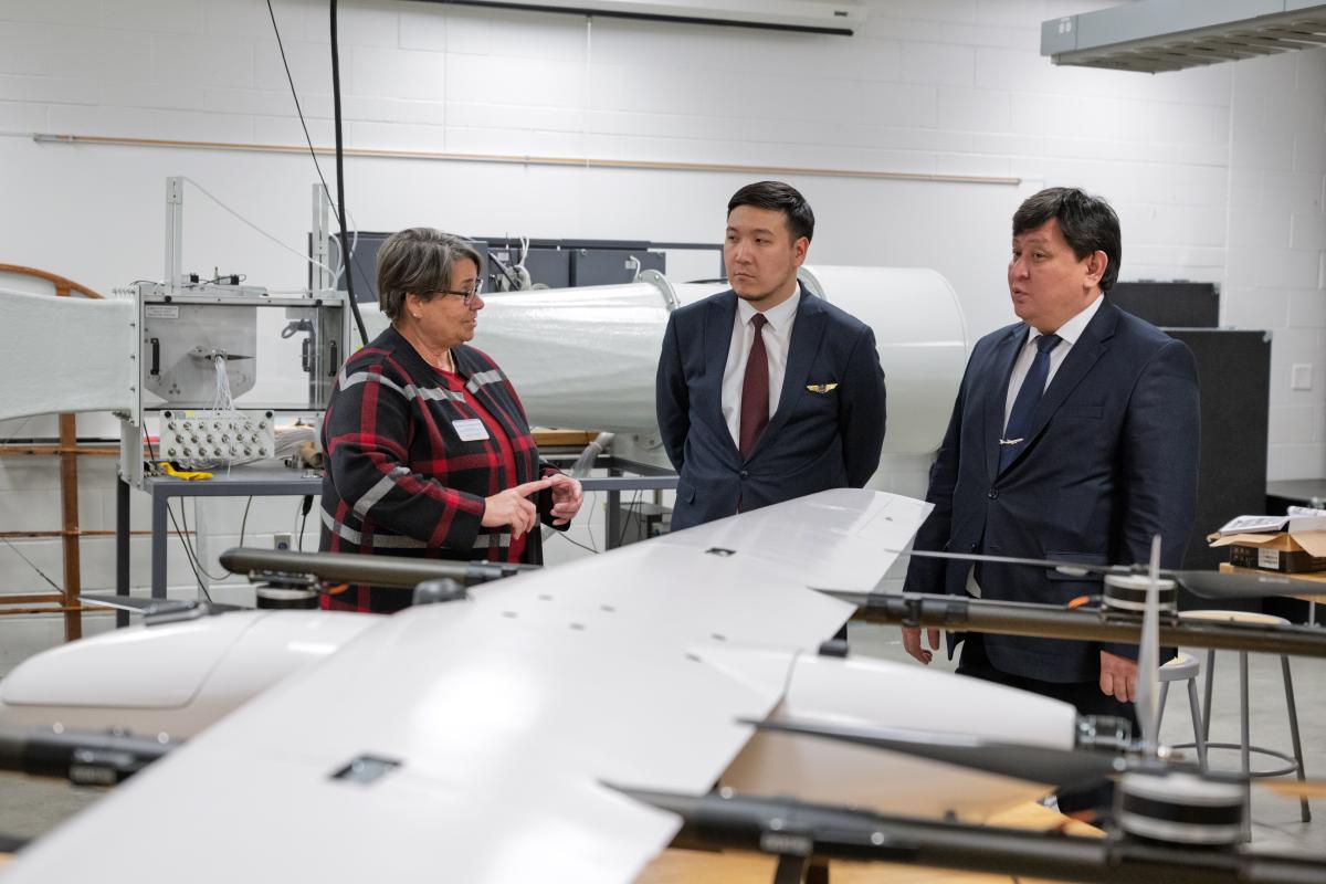 Officials from the Civil Aviation Academy in Almaty, Kazakhstan tour the College of Aeronautics and Engineering with Dean Christina Bloebaum.