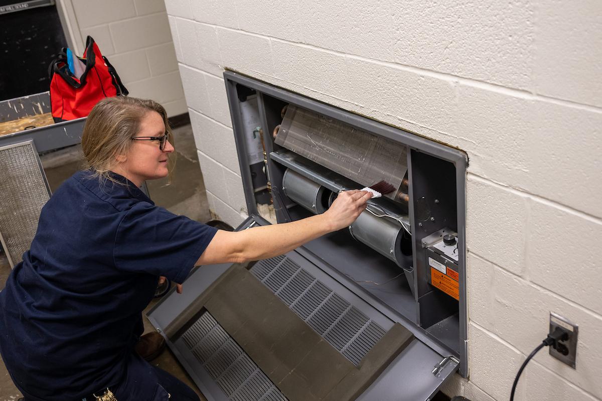 UFM crew cleaning a heating unit.