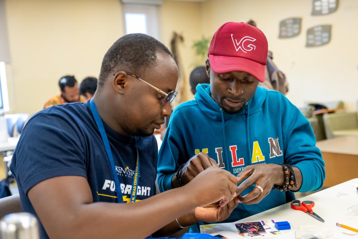On right, Franklin Zaure, of Nigeria, works on assembling a hand.