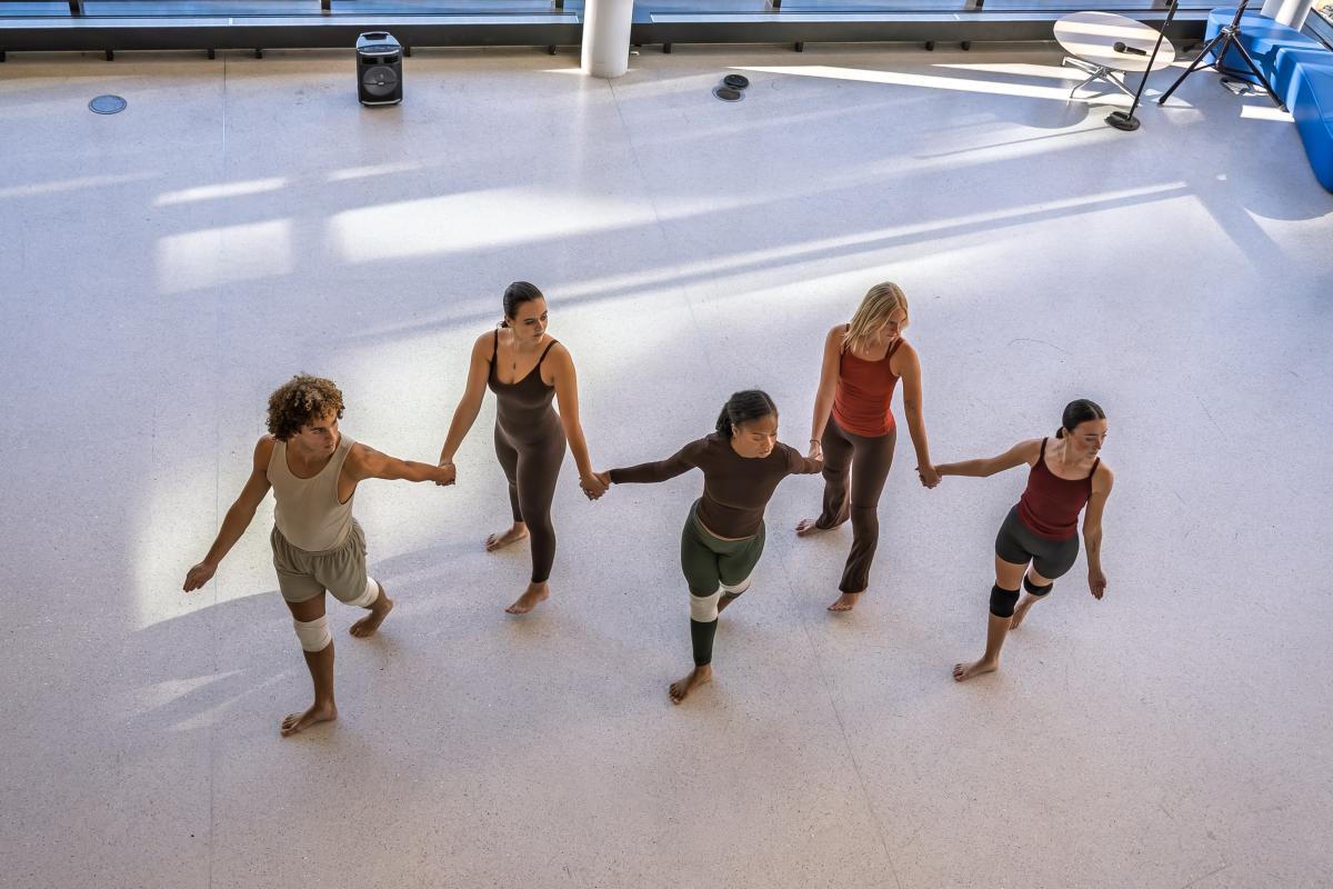 Student dancers perform the Pledge, in the Integrated Sciences Building lobby.