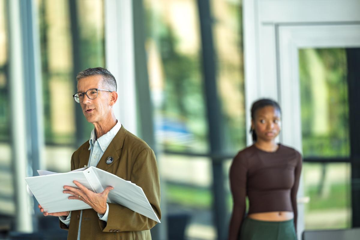 Eric Schmiedl, actor and adjunct professor of theater and dance, takes part in the performance of the poem the Pledge.