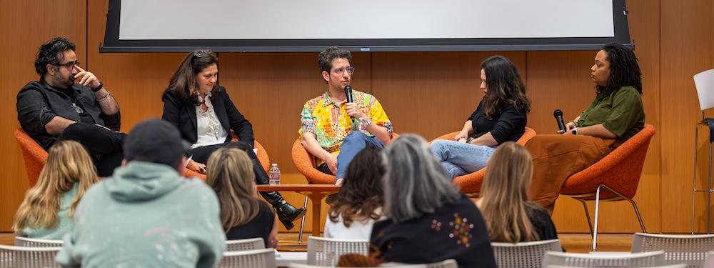 Adam Nathaniel Furman and a panel of faculty