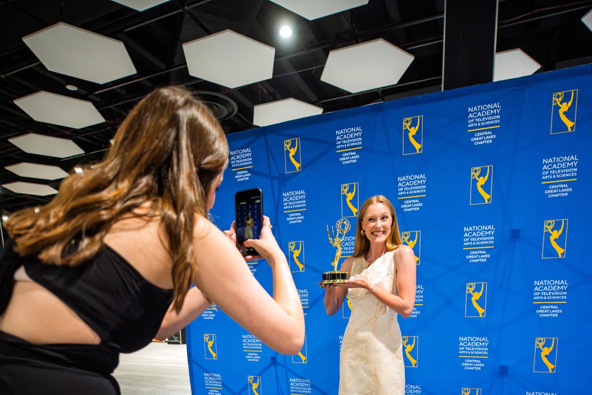Recent graduate Sydney Brown celebrates after receiving a reporting award at the regional Emmy Awards, June 2026