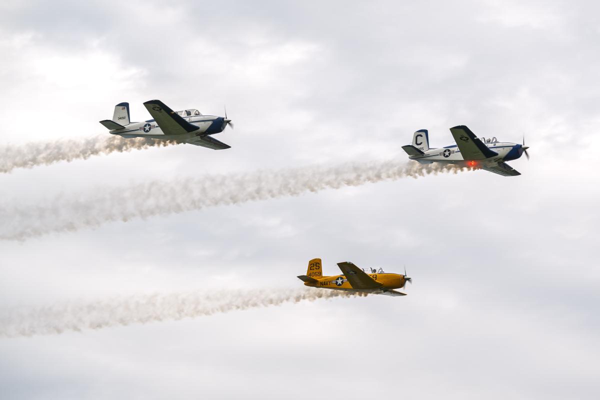 Three planes of a nine-ship formation passing low over the runway at Kent State University Airport.