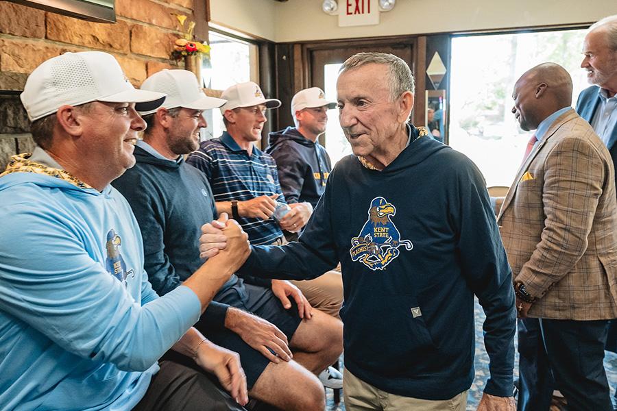 Coach Herb Page greets alumni of Kent State's golf program