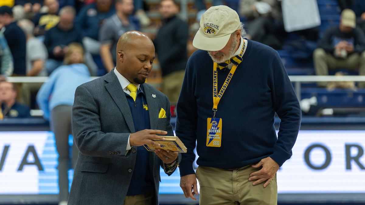 Randale Richmond shows President Diacon the floorboard commemorative item.