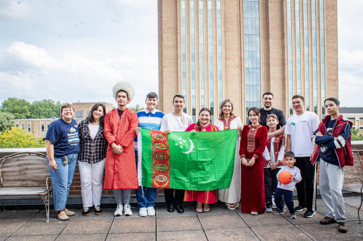 Arslan and other students holding up a flag 