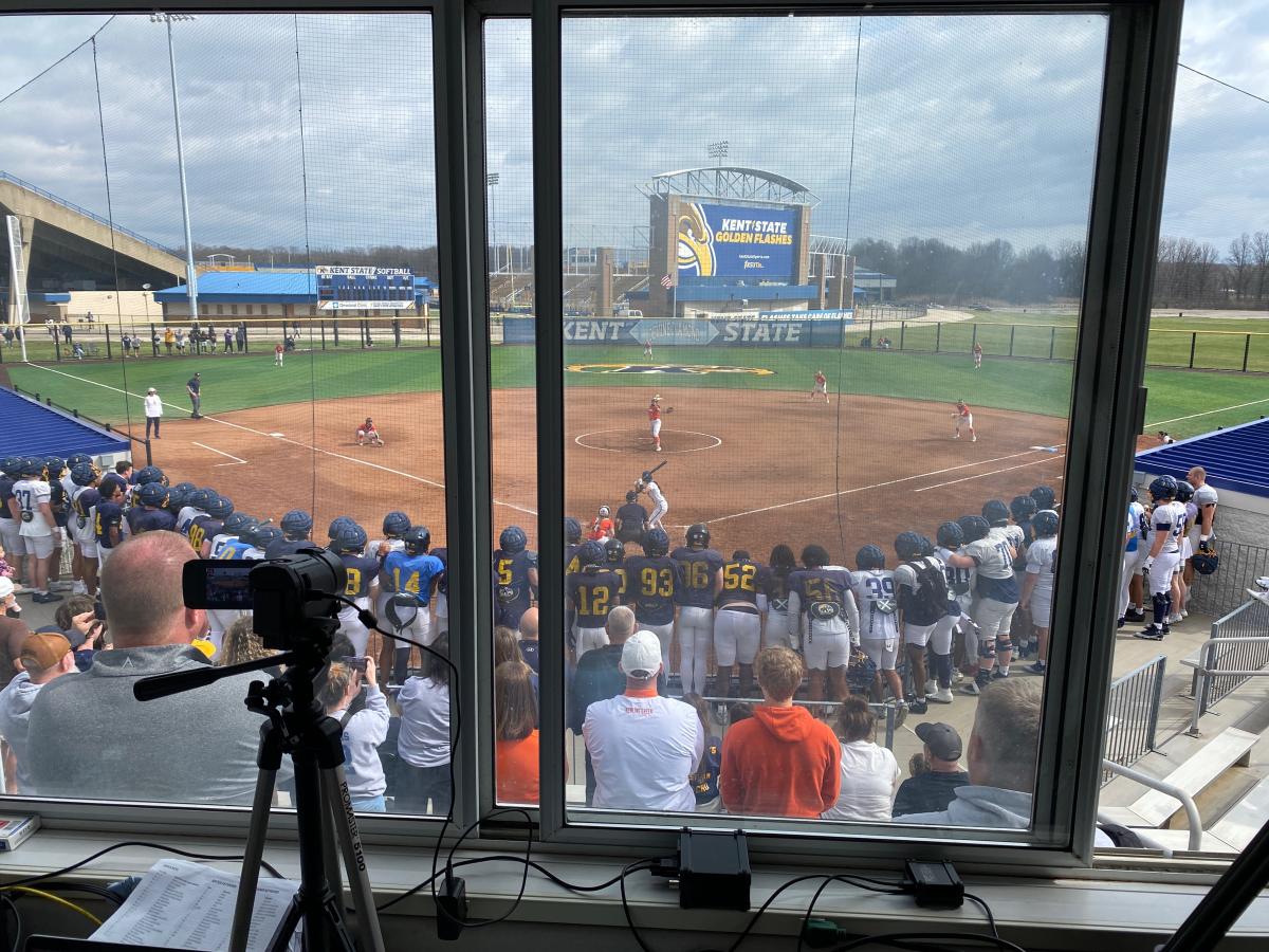 Football team supporting softball team.