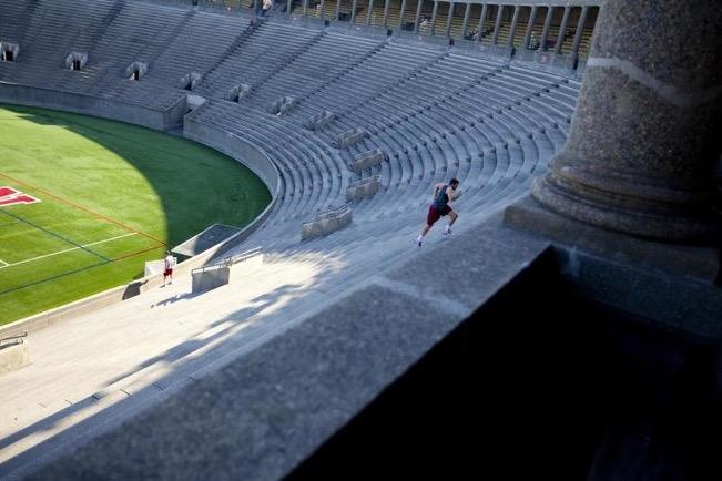 Empty stadium with runner doing stairs