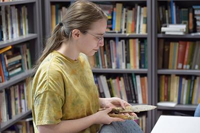 Anna Mika looks at the stone knives she created in the Experimental Archaeology Lab