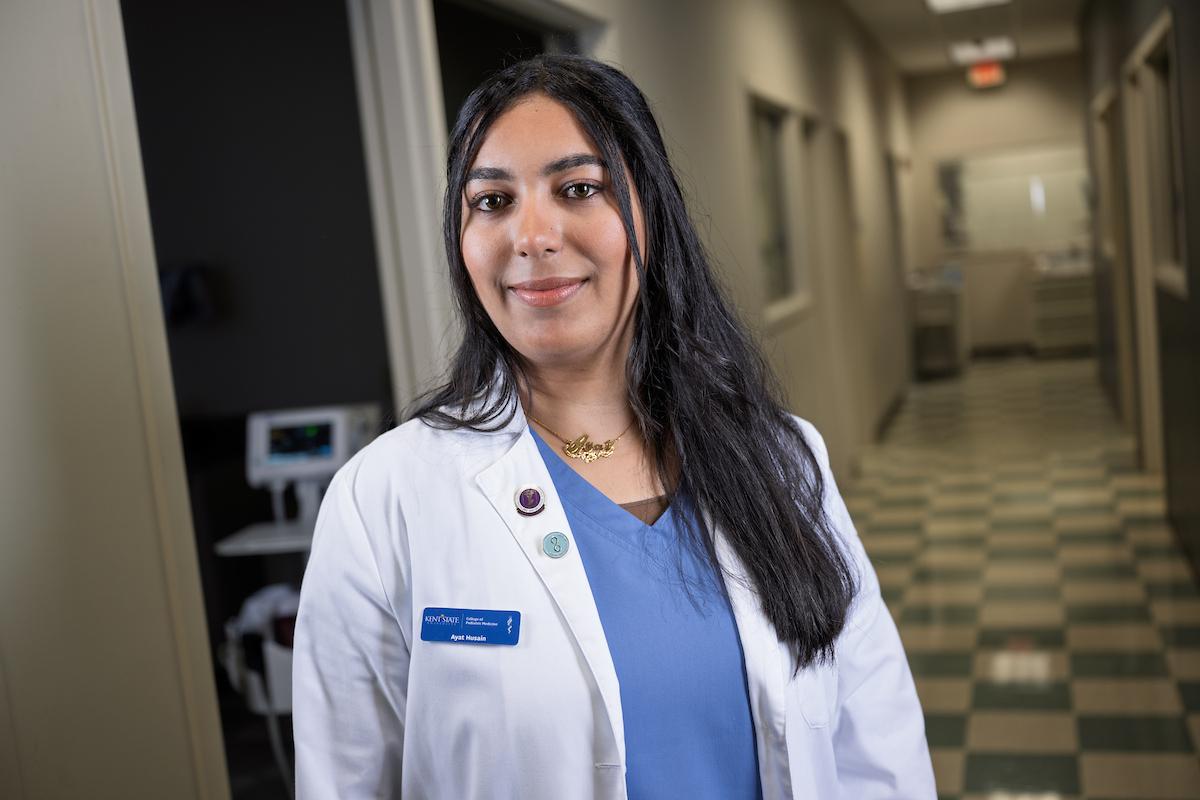 Ayat Husain, a student at С��Ƭ��Ƶ's College of Podiatric Medicine, stands in the hallway of the college's clinic. (Photo credit: Bob Christy)