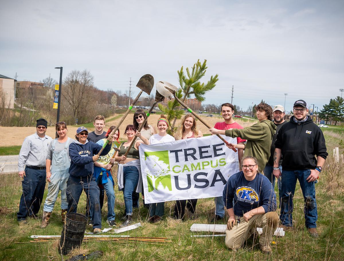 Bekkah Berryhill with a group holding a Tree City USA Banner. 