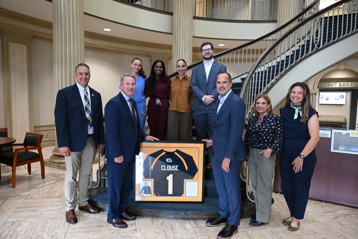 U.S. Senator John Husted receives framed jersey of family member who was athlete at Kent State
