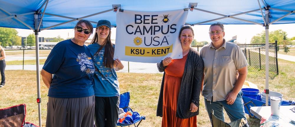 Bee Campus USA Committee poses for a photo under the tent