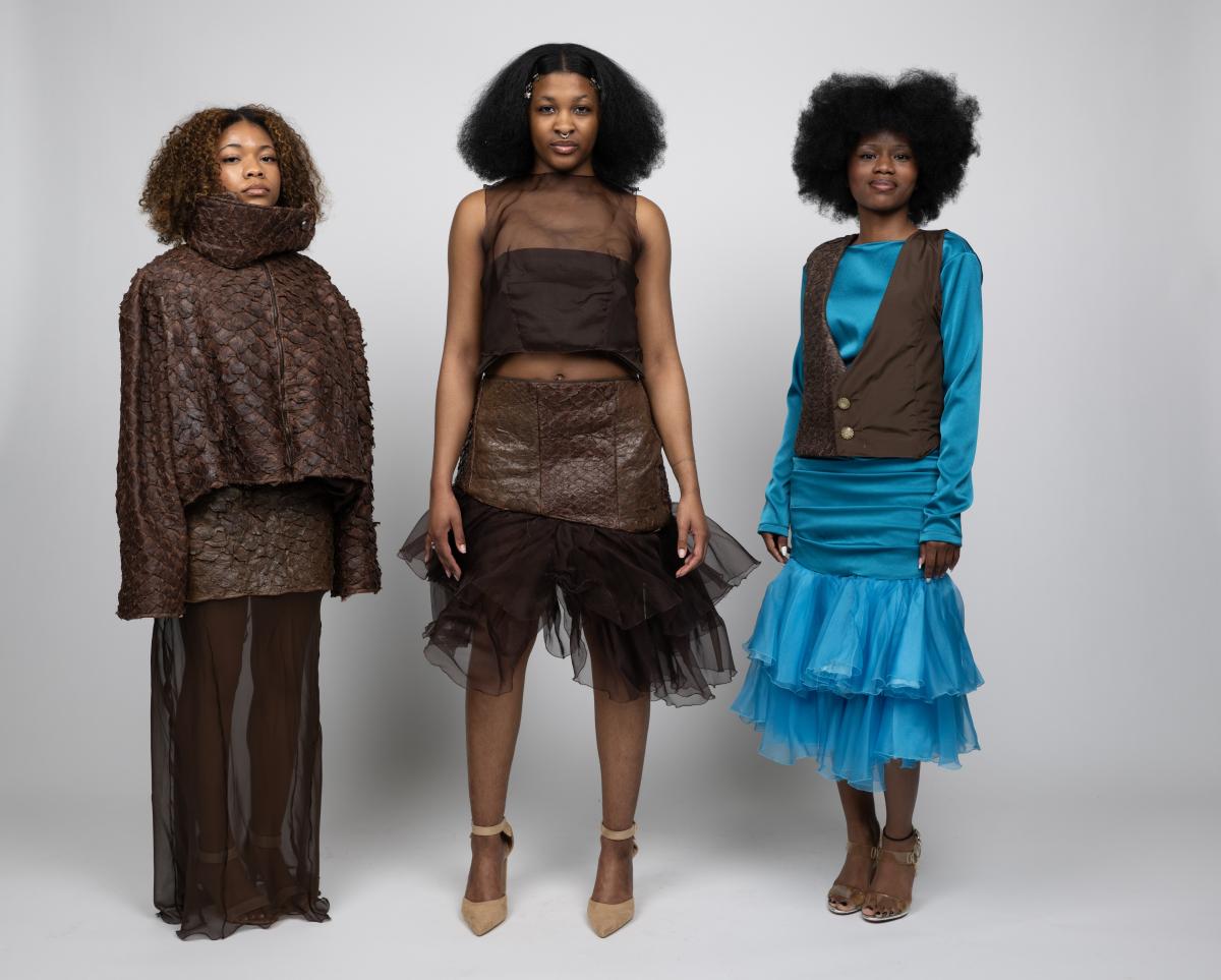 models wear a variety of brown and blue garments featuring textures similar to a lizards scales