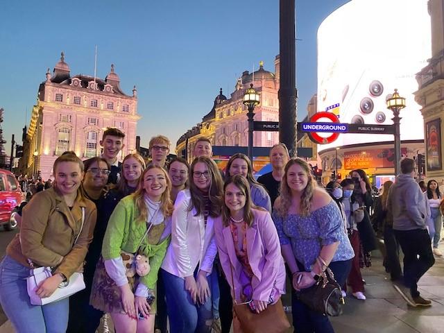 Students at a busy square in London in the evening