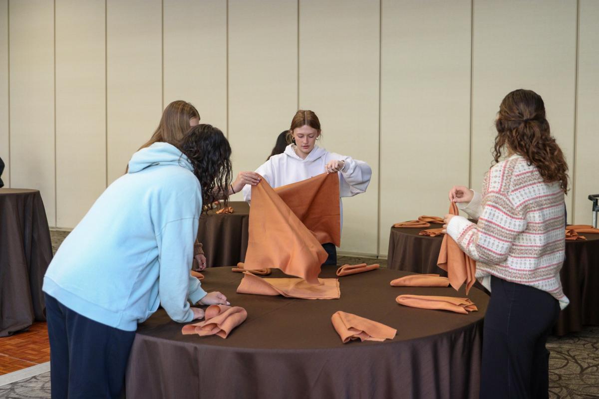 Students preparing tables for the reception. 