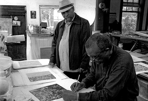 Curlee Holton and David Driskell in the print shop signing prints