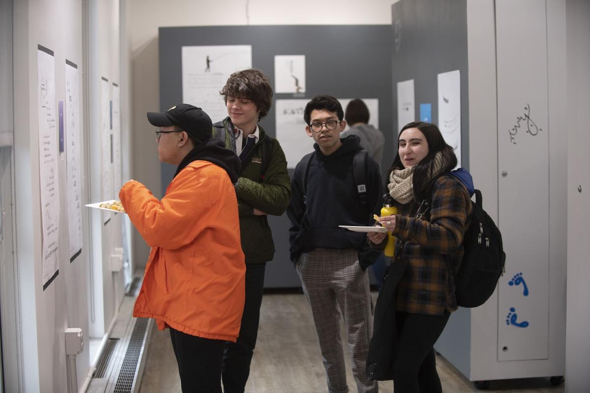 Students admire work at the Concrete Poetry Gallery Opening