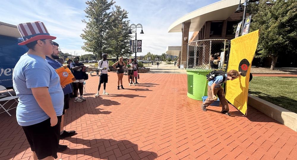 Skains, left, watches the dunk tank in action