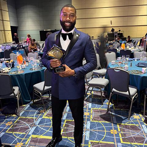 Diauntae Morrow with his Emerging Leader Award at the NAAIA conference.