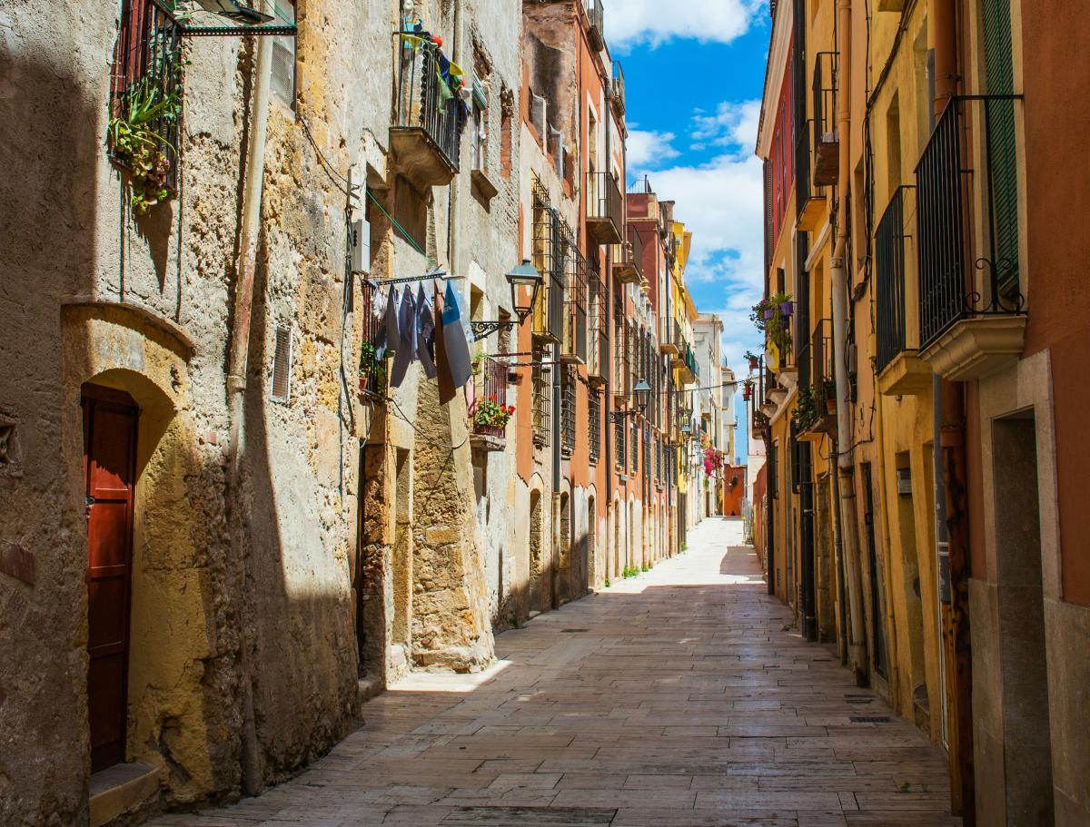 European streets with stone walkway and tall buildings during the daytime.