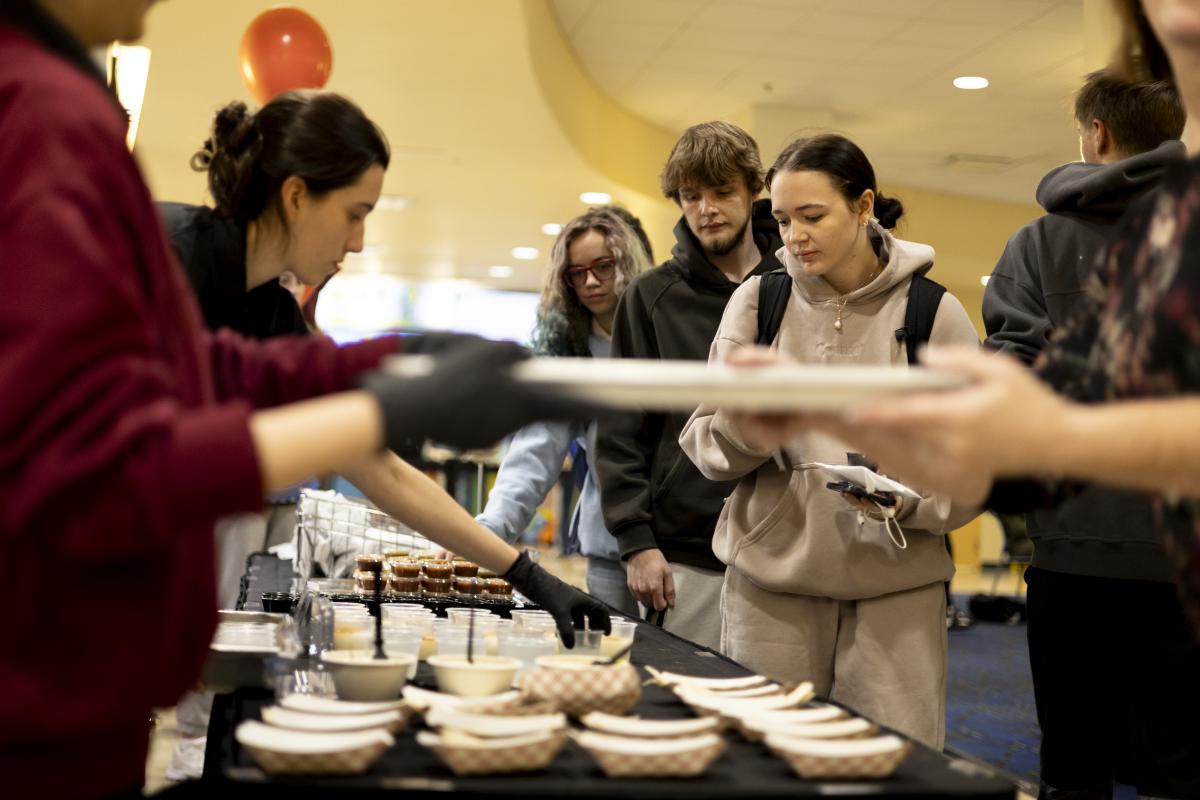 Student doing line to get food samples