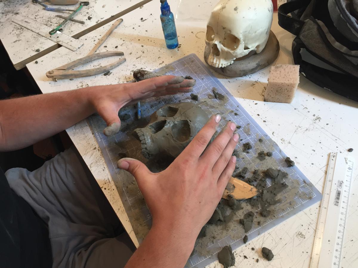 Students shaping their clay skulls.