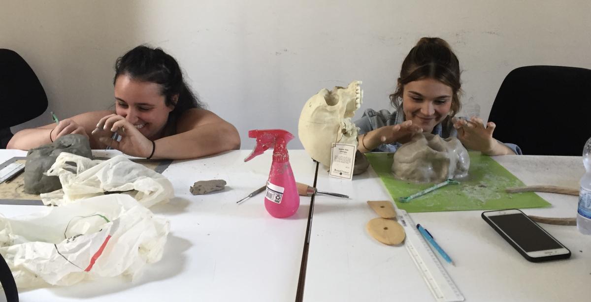 Students shaping their clay skulls.
