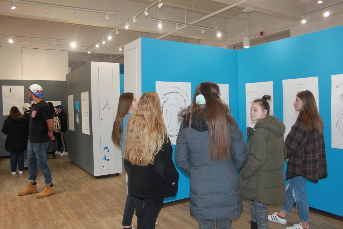 Students admire work at the Concrete Poetry Gallery Opening