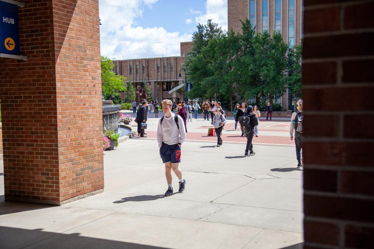 Students walk across Risman Plaza on the first day of fall classes. 