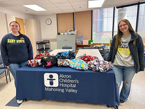 Honors nursing students Jennifer Tedrow and Zoey Almy with the blankets made and donated to Akron Children鈥檚 Hospital.