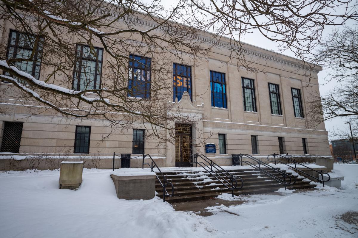 Exterior view of the Kent State Museum on a snowy day, with bare trees in the foreground.