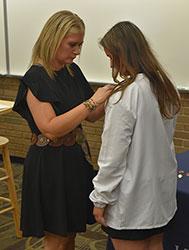 Allie Gries receives her pin from a loved one.