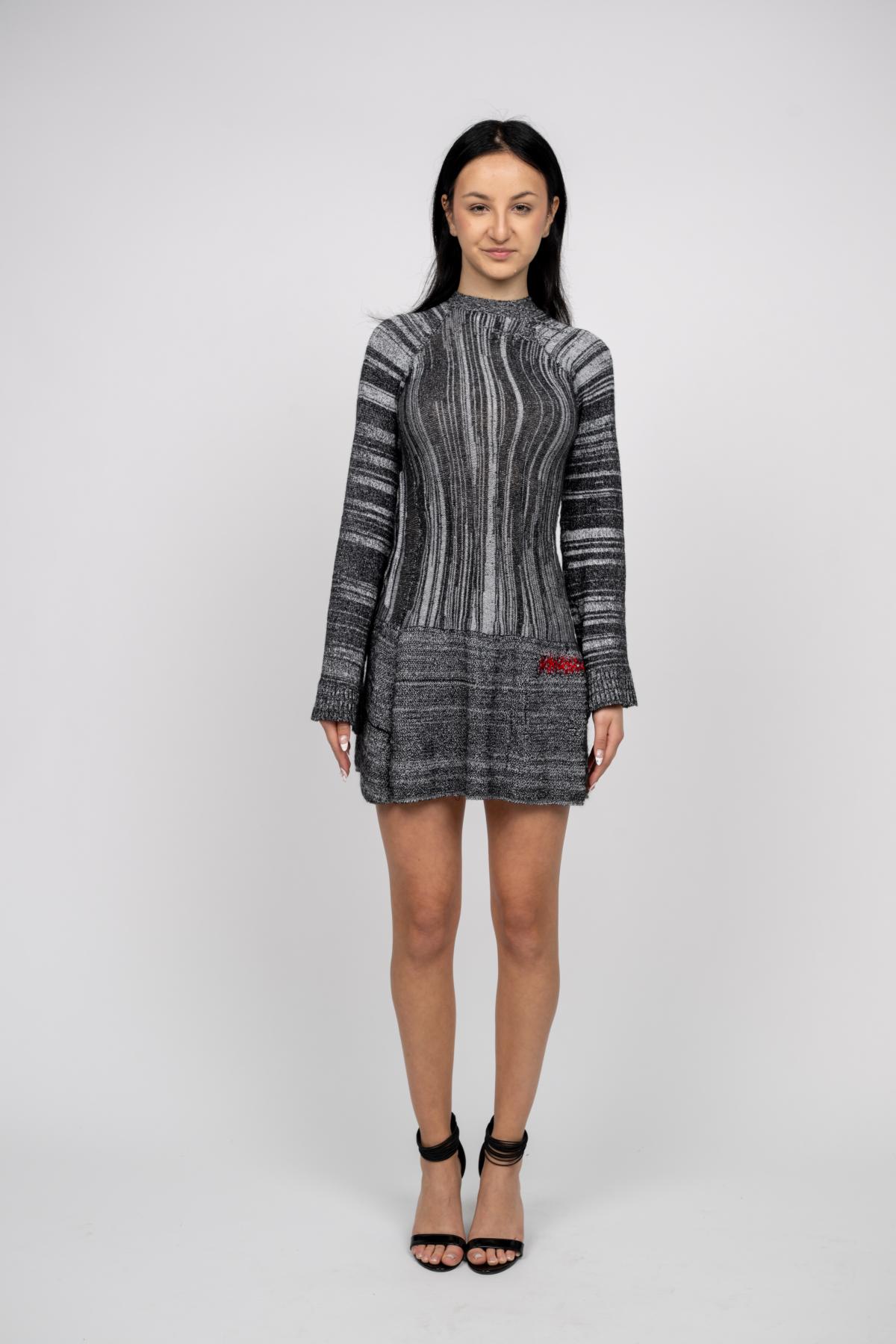 a model wears a long sleeve mini dress with a striped pattern