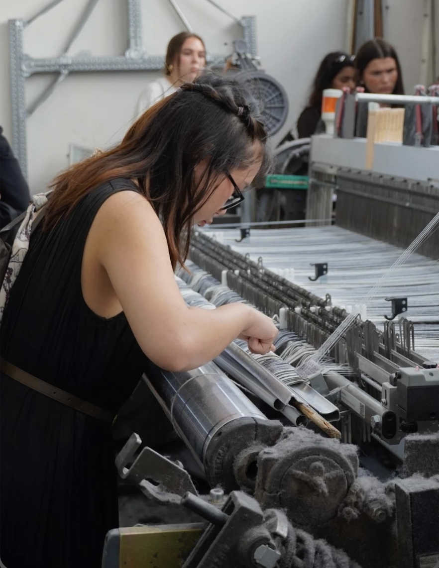 Anna adjusting a machine while studying abroad in Florence, Italy.