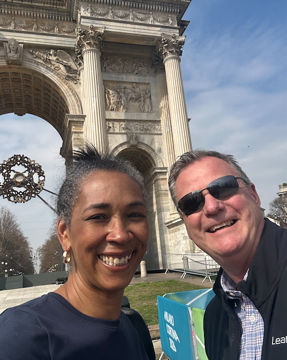 Betsy Ann and her professor next to a historic arch.